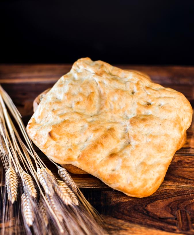 Artisan focaccia on wooden board - Frontier Bakery hand-stretched focaccia